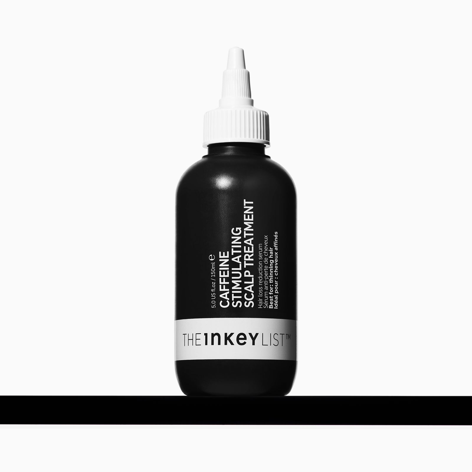 The INKEY List Caffeine Stimulating Scalp Treatment, 150 ml black bottle with a white precision nozzle.